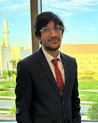 Portrait of Sarabesh Ravindranath in a navy suit